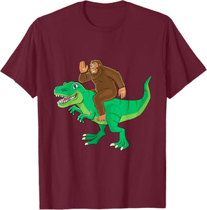 Bigfoot Riding Dinosaur T Rex Funny Men Boys Sasquatch Lover T-Shirt - T-Shirt | Maroon