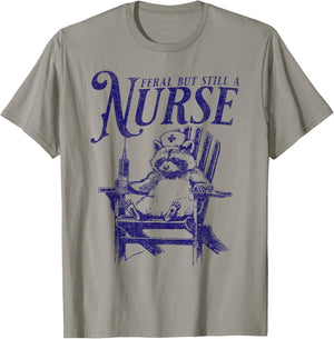 Feral But Still A Nurse Funny Feral Nurse Raccoon Nurse T-Shirt - T-Shirt | Sand